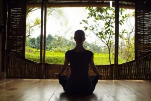 Woman meditating at resort in Bali