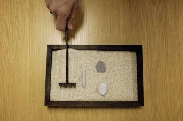 Woman Raking Zen Garden
