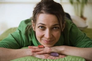 Portrait of woman with hands on chin looking at camera