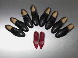 Row of Dress Shoes Surround High Heels